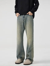 Men’s full size wash wide leg bootcut jeans with faded denim and distressed finish along the thighs