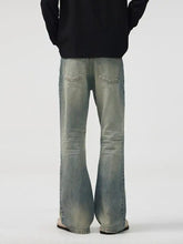 Men’s light-wash denim full size wash wide leg bootcut jeans with faded distressed look and subtle thigh fading