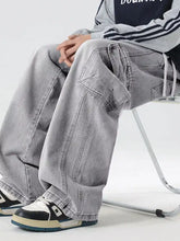 Men’s light-wash denim cargo jeans featuring multiple pockets and a relaxed fit in wash wide leg style