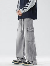 Men’s light gray wide leg cargo jeans made of denim with multiple pockets and a drawstring waist in full size wash wide leg style