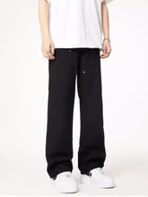 Men’s full size wash wide leg jeans in black with subtle silver button accents for a stylish plus size fit