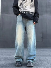 Men’s full size wash wide leg jeans in light-wash denim with faded distressing and a wide-leg cut