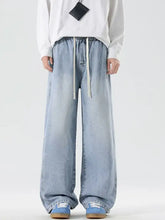 Men’s plus size light-wash denim wide leg jeans with drawstring waist and subtle fading for comfortable style