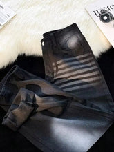 Men’s black denim full size wash wide leg jeans with faded distressed look and horizontal striped detailing on thigh