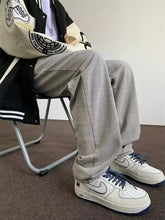 Men’s full size wash wide leg jeans paired with cream nike air force 1 sneakers with navy laces and black sole
