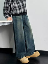 Men’s full size wash wide leg jeans in faded dark blue denim with subtle whiskering and frayed hems