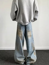 Men’s full size wash wide-leg jeans feature faded denim with a distressed look and subtle brownish stains