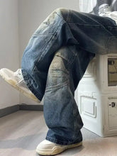 Mens full size wash wide leg jeans in faded denim with distressed look and reinforced patchwork for perfect fit
