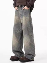 Men’s plus size wide-leg jeans in faded distressed gray wash with subtle fading patterns in denim material