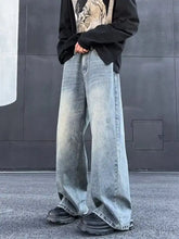 Men’s full size wash wide leg jeans in faded light blue denim with subtle distressing and raw hem detailing