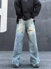 Men’s full size wash wide leg jeans in faded light blue denim with subtle distressing and plus size fit