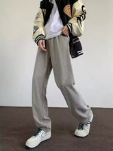 Men’s gray wide leg jeans with full size wash, relaxed fit, and visible stitching details in denim material