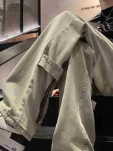 Men’s light-wash denim wide-leg jeans plus size with visible stitching and zipper detail on the side cargo pocket
