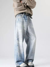 Men’s full size wash wide leg jeans in light-wash denim with a faded, distressed look and subtle fading patterns