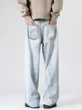 Men’s full size wash wide leg jeans in light-wash denim with a faded, distressed look and wide-leg cut
