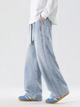 Men’s plus size light-wash denim wide-leg jeans with drawstring waist and subtle stitching details