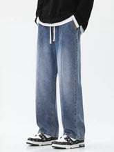 Men’s light-wash denim wide-leg jeans with relaxed straight-leg cut and white drawstring waistband full size plus size