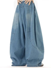 Men’s full size wash wide leg jeans in faded blue denim with relaxed fit and visible stitching details