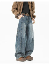 Men’s full size wash wide leg jeans in medium-wash blue denim with visible stitching and patch pockets