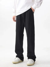 Men’s black straight-leg trousers with relaxed fit made from smooth fabric for comfortable wear