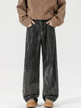 Men’s full size wash wide leg relaxed fit black denim jeans with faded distressed texture and subtle white streaks
