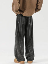 Men’s full size wash black wide-leg denim jeans with faded distressed texture, visible stitching, and relaxed fit