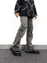 Men’s full size washed flare jeans in gray denim with flared legs and multiple cargo pockets featuring subtle distressing