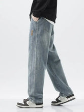 Men’s light-wash denim jeans with relaxed washed loose fit and subtle fading in a fit wide leg style plus size
