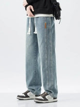 Men’s full size washed loose fit light-wash denim jeans with relaxed fit wide leg and white drawstring waist