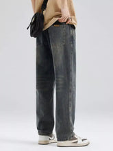 Men’s full size washed relaxed fit jeans in dark gray denim with visible stitching and a slightly faded look