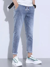 Men’s full size washed skinny jeans in light wash denim with slim fit, rolled cuffs, and drawstring waistband details