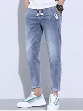 Men’s light-wash denim jogger pants with drawstring waist and rolled cuffs in plus size washed skinny jeans style