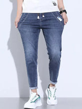 Men’s full size washed skinny jeans in blue denim with slim fit rolled cuffs and white drawstrings at the waist