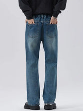 Men’s full size washed blue denim straight leg jeans showing the back side with relaxed fit and visible pockets
