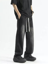 Men’s full size black wide leg denim jeans with white drawstrings and faded distressed texture in plus size