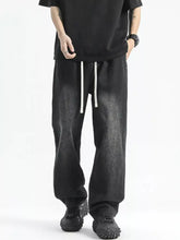 Men’s full size washed wide leg black jeans with subtle texture and contrasting white drawstring waistband
