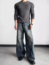 Dark gray ribbed knit long-sleeve henley shirt paired with men’s full size washed wide leg jeans for casual wear