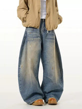 Men’s full size washed wide leg jeans in faded blue denim with intentional distressing details