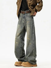 Men’s full size washed gray denim wide leg jeans with distressed patches and a relaxed wide leg cut