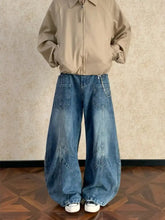 Men’s full size washed wide leg jeans in medium blue denim with visible stitching and patch pockets