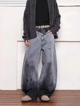 Men’s full size washed wide leg denim jeans with faded gray-to-black gradient wash and distressed spots