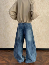 Men’s full size washed wide leg jeans in blue denim with classic back pockets shown from the back side