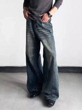 Men’s full size washed dark wash denim wide leg jeans with relaxed fit and visible stitching details