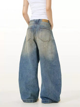 Men’s full size washed wide leg jeans in faded blue denim with subtle distressing and wide leg design