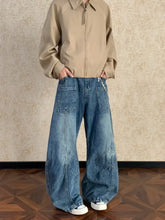 Men’s full size washed wide leg jeans in faded blue denim with distinctive diagonal stitching details