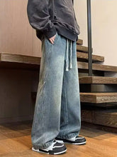 Men’s full size washed wide leg jeans in faded blue denim with a drawstring waistband for comfortable wear