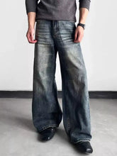 Men’s full size washed wide leg jeans in faded dark blue denim with subtle distressing and classic five-pocket design