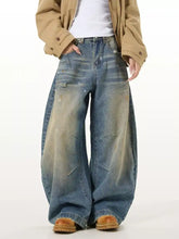 Men’s full size washed wide leg jeans in denim with faded distressed look and subtle paint-splatter detailing