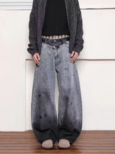 Men’s full size washed wide leg jeans in faded gray denim with intentional dark distressing at the bottom