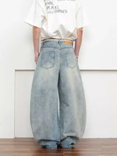 Men’s full size light-wash denim washed wide-leg jeans with a relaxed balloon silhouette and classic back pockets viewed from back